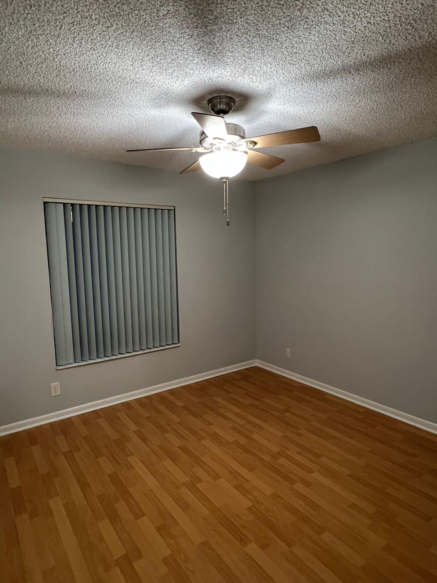 2335 Southwest 22nd Avenue, Unit 1030 Delray Beach, FL 33445 - Photo 18 of 41 a view of an empty room with wooden floor