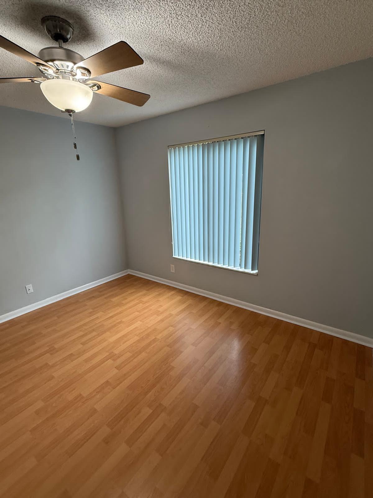 2335 Southwest 22nd Avenue, Unit 1030 Delray Beach, FL 33445 - Photo 22 of 41 wooden floor in an empty room with a window