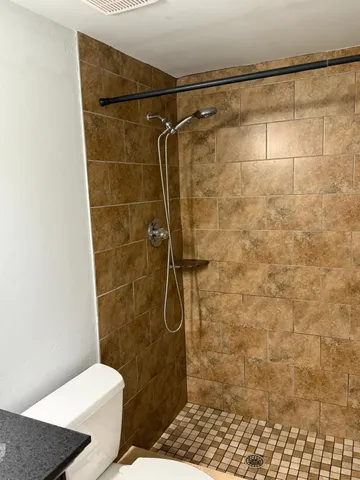 a bathroom with a toilet and a bath tub