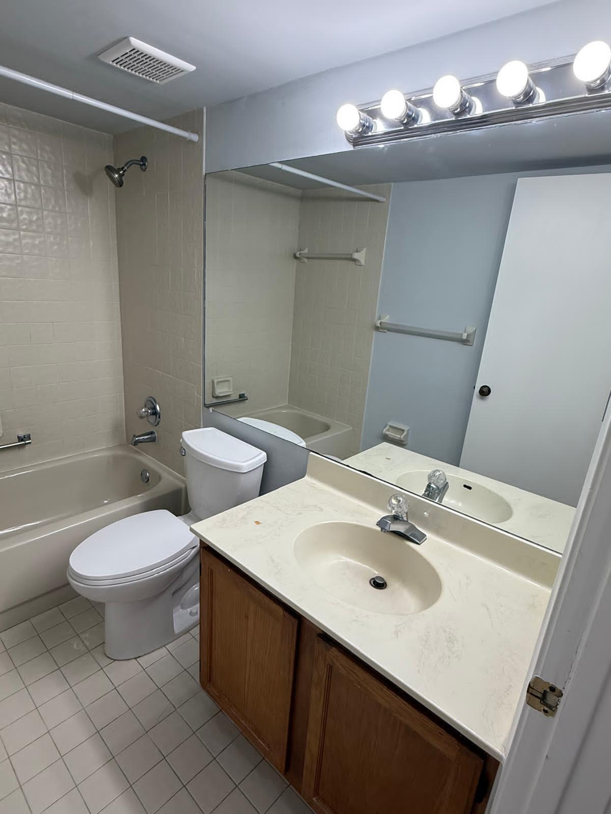 2335 Southwest 22nd Avenue, Unit 1030 Delray Beach, FL 33445 - Photo 32 of 41 a bathroom with a sink toilet and a mirror