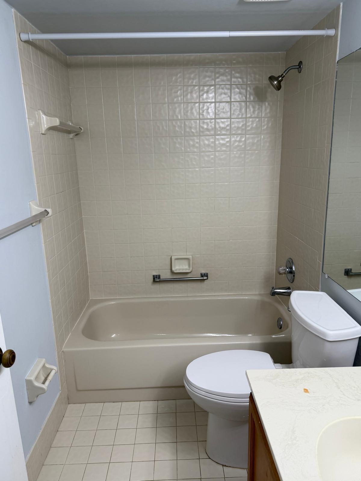 2335 Southwest 22nd Avenue, Unit 1030 Delray Beach, FL 33445 - Photo 33 of 41 a bathroom with a toilet and a bath tub