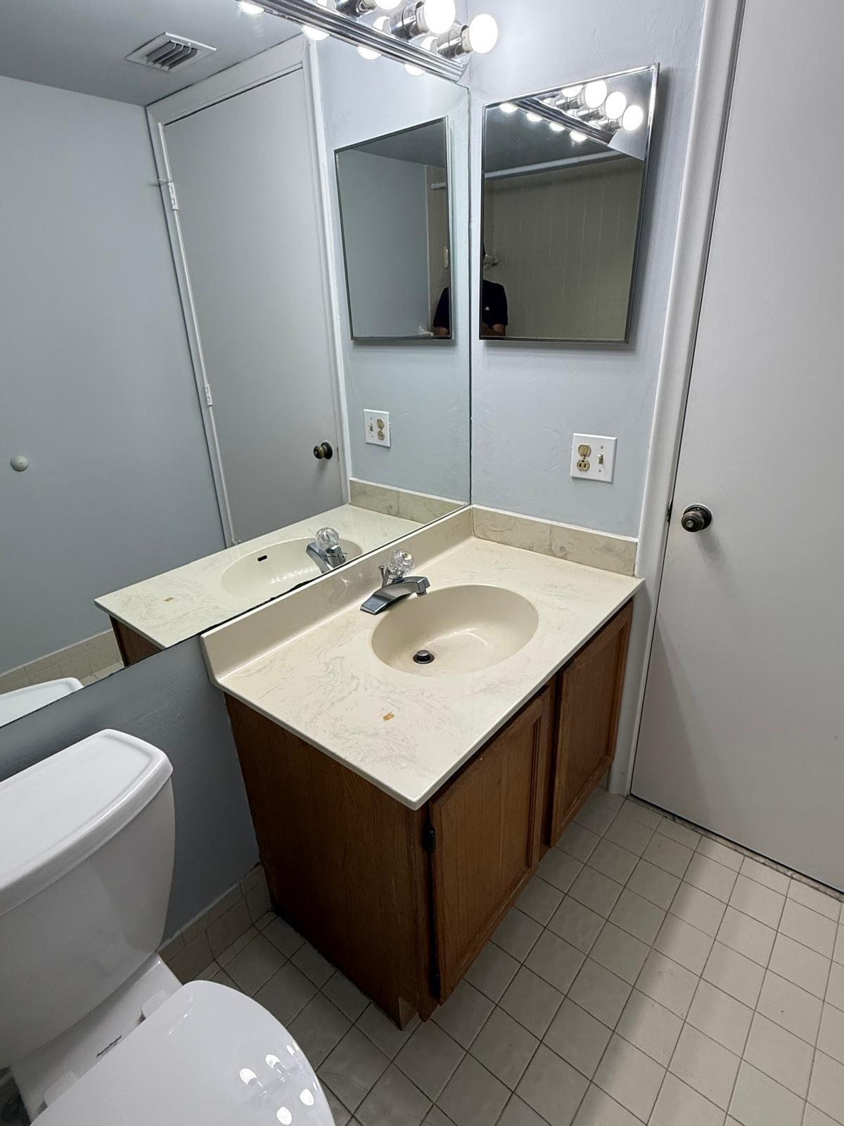2335 Southwest 22nd Avenue, Unit 1030 Delray Beach, FL 33445 - Photo 35 of 41 a bathroom with a sink vanity and toilet