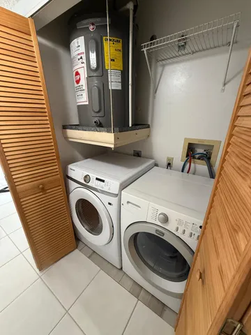 a view of an empty room with cabinet and wooden floor