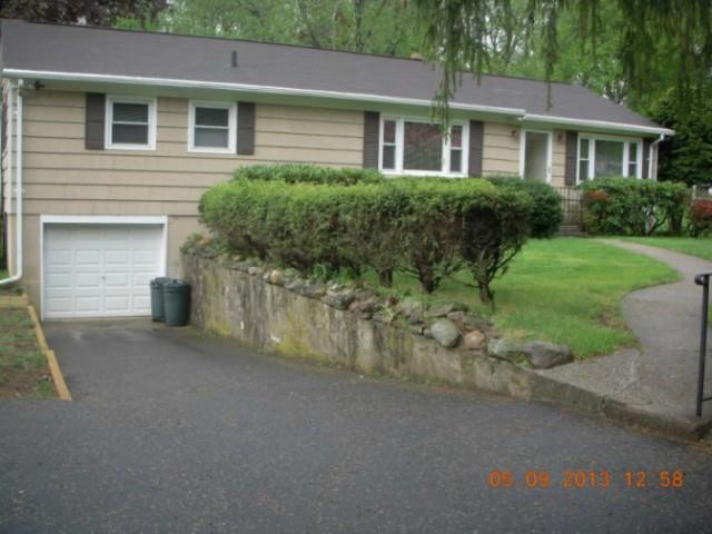 155 Putting Green Road Fairfield, CT 06825 - Photo 1 of 1 a front view of a house with a yard and garage
