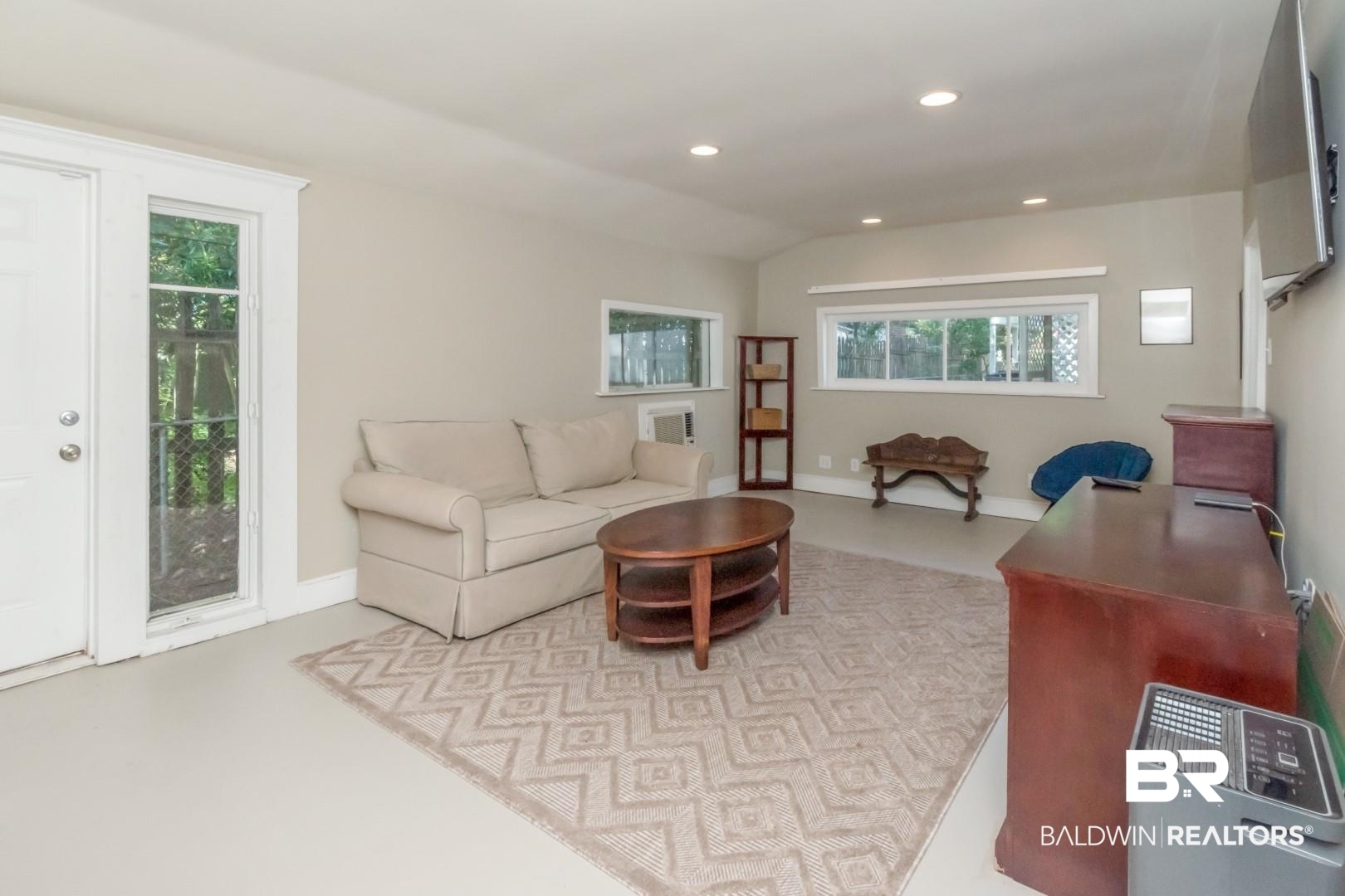 116 Florence Place Mobile, AL 36607 - Photo 38 of 41 Living room with a healthy amount of sunlight and vaulted ceiling