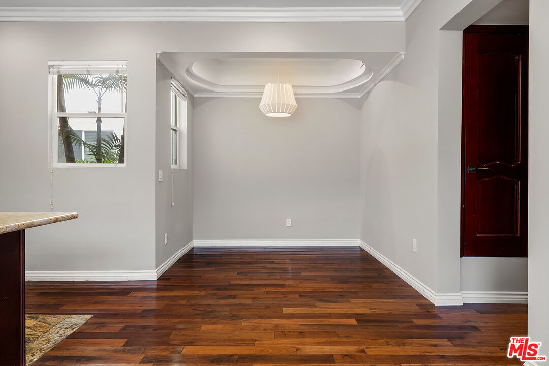 632 North Kings Road, Unit 102 West Hollywood, CA 90048 - Photo 4 of 13 a view of an empty room with wooden floor and a window