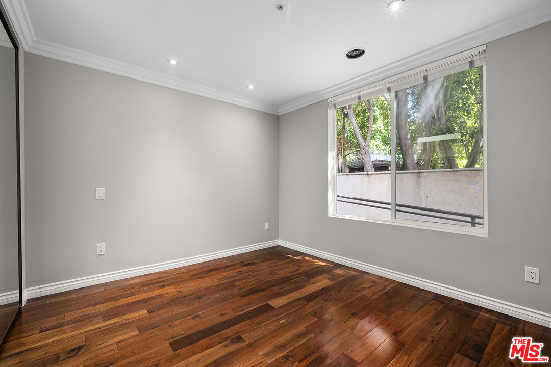 632 North Kings Road, Unit 102 West Hollywood, CA 90048 - Photo 6 of 13 a view of empty room with wooden floor and fan
