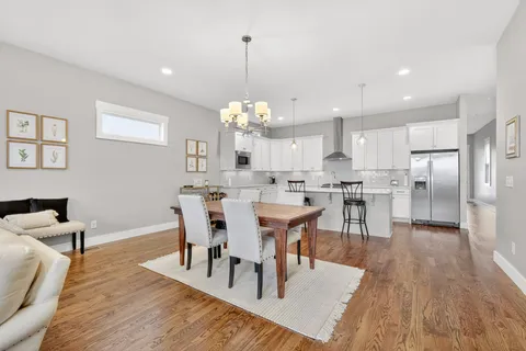 a view of a dining room with furniture and wooden floor
