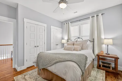 a bedroom with a bed and a chandelier