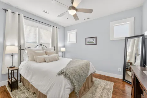 a bedroom with a bed and a refrigerator