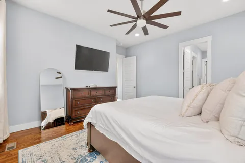 a bedroom with a bed and a flat screen tv