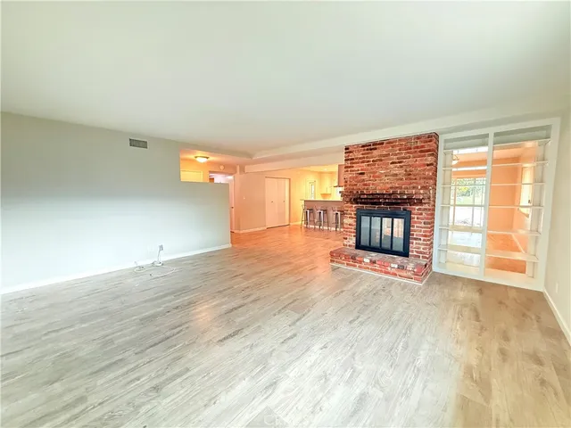 a view of an empty room and wooden floor