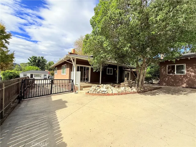 a view of a balcony with wooden floor and fence