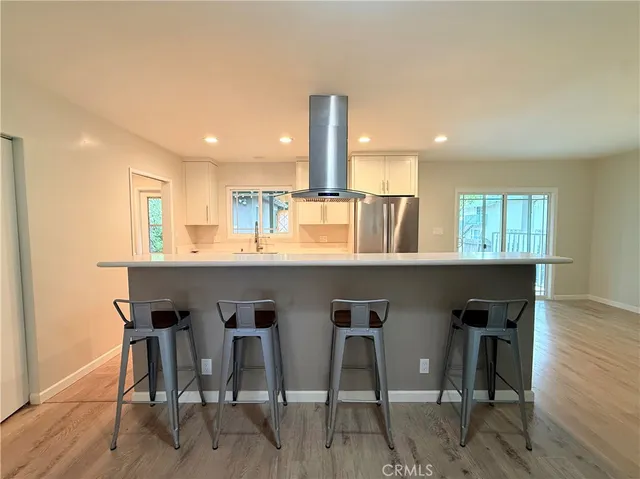 a utility room with wooden floor washer and dryer