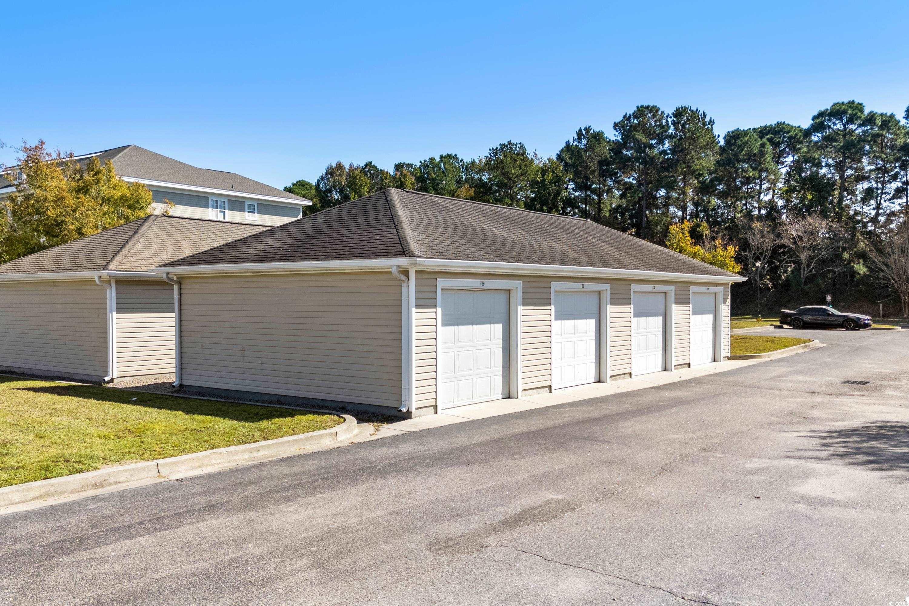 336 Kiskadee Loop, Unit B Conway, SC 29526 - Photo 32 of 40 Garage with a lawn