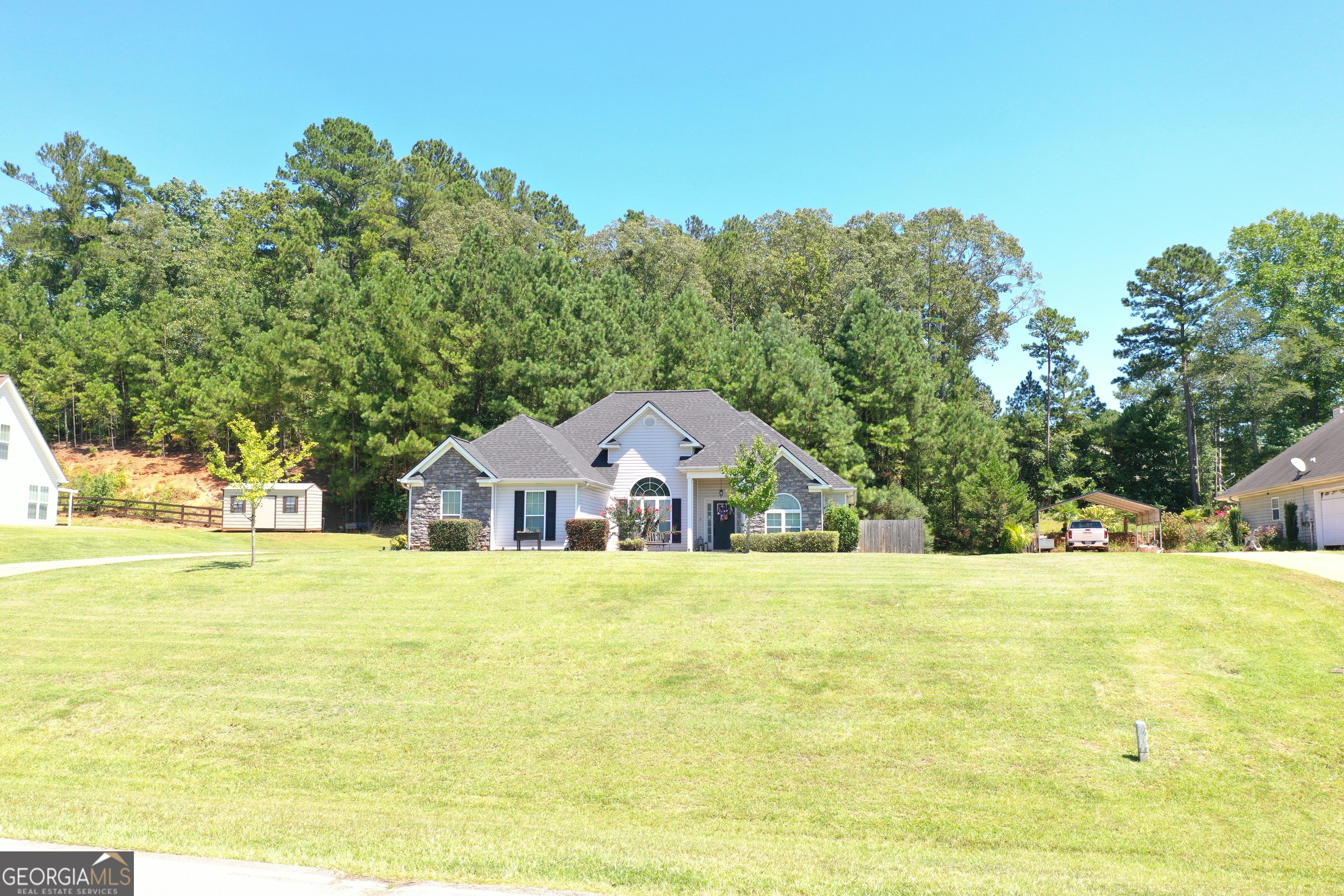 229 John Lovelace Road LaGrange, GA 30241 - Photo 50 of 59 a front view of a house with a garden and trees