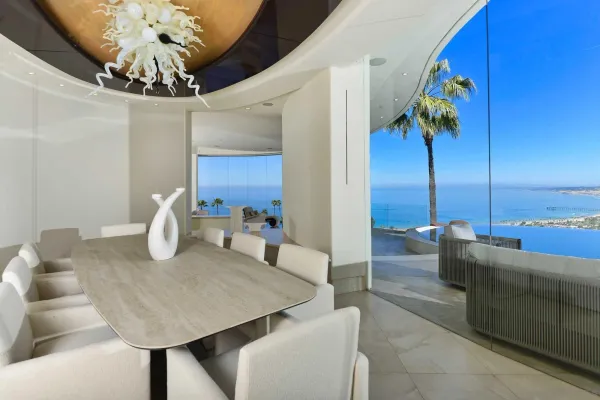 a view of a dining room with furniture and chandelier
