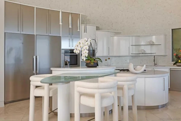 a kitchen with stainless steel appliances granite countertop a sink and a refrigerator