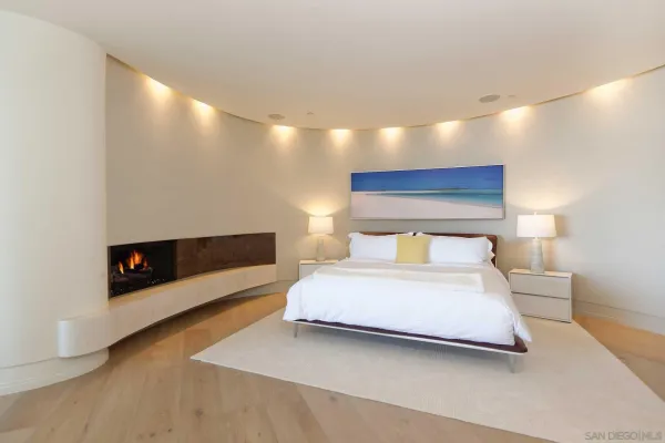 a bedroom with a bed and a night stand