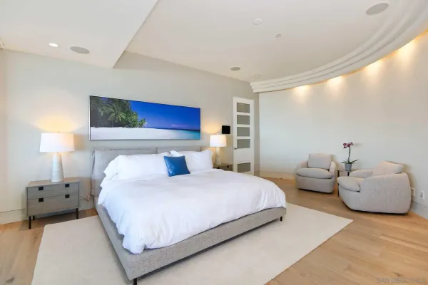 a bedroom with bed and large mirror