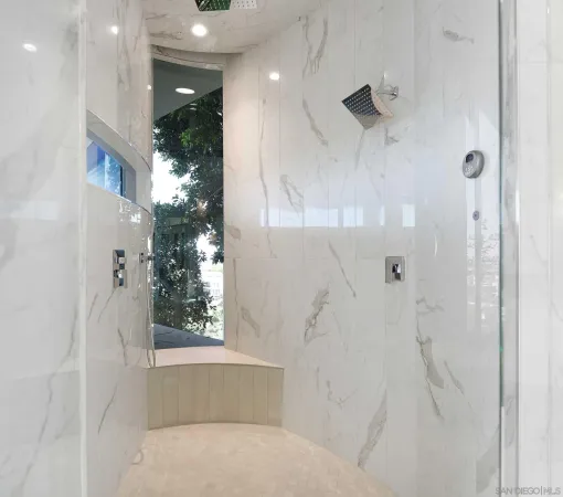 a bathroom with a glass shower door