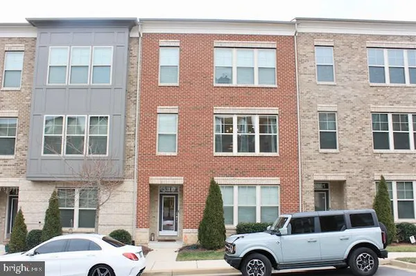 a cars parked in front of a brick building