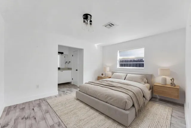 a bedroom with a bed and a lamp