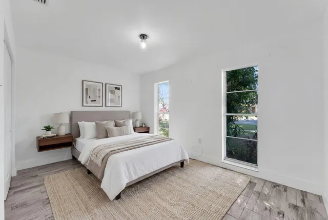 a bedroom with a bed and a window