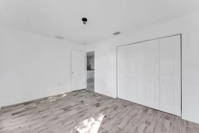 a view of a room with wooden floor