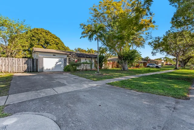 a view of a house with a yard and garage