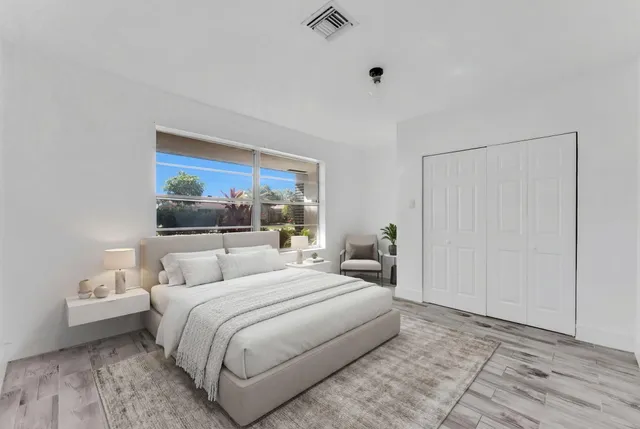 a bedroom with a bed a window and a walk in closet