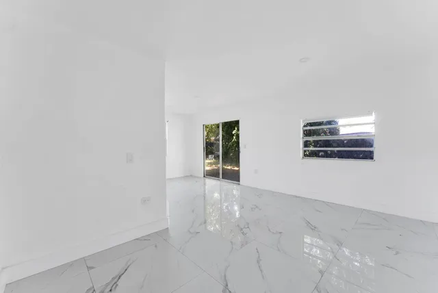 a view of an empty room with entertaining space