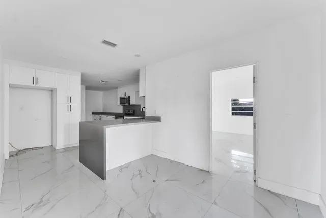 a kitchen with cabinets and white appliances