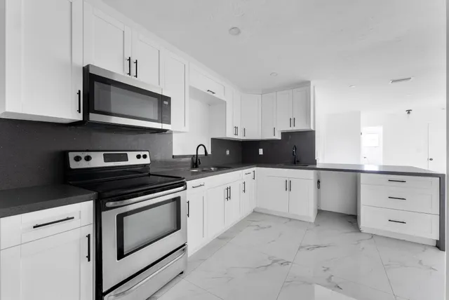 a kitchen with cabinets and appliances