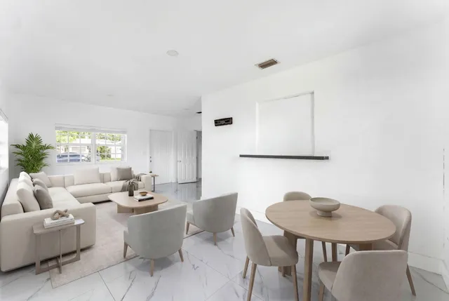 a living room with furniture a window and a table