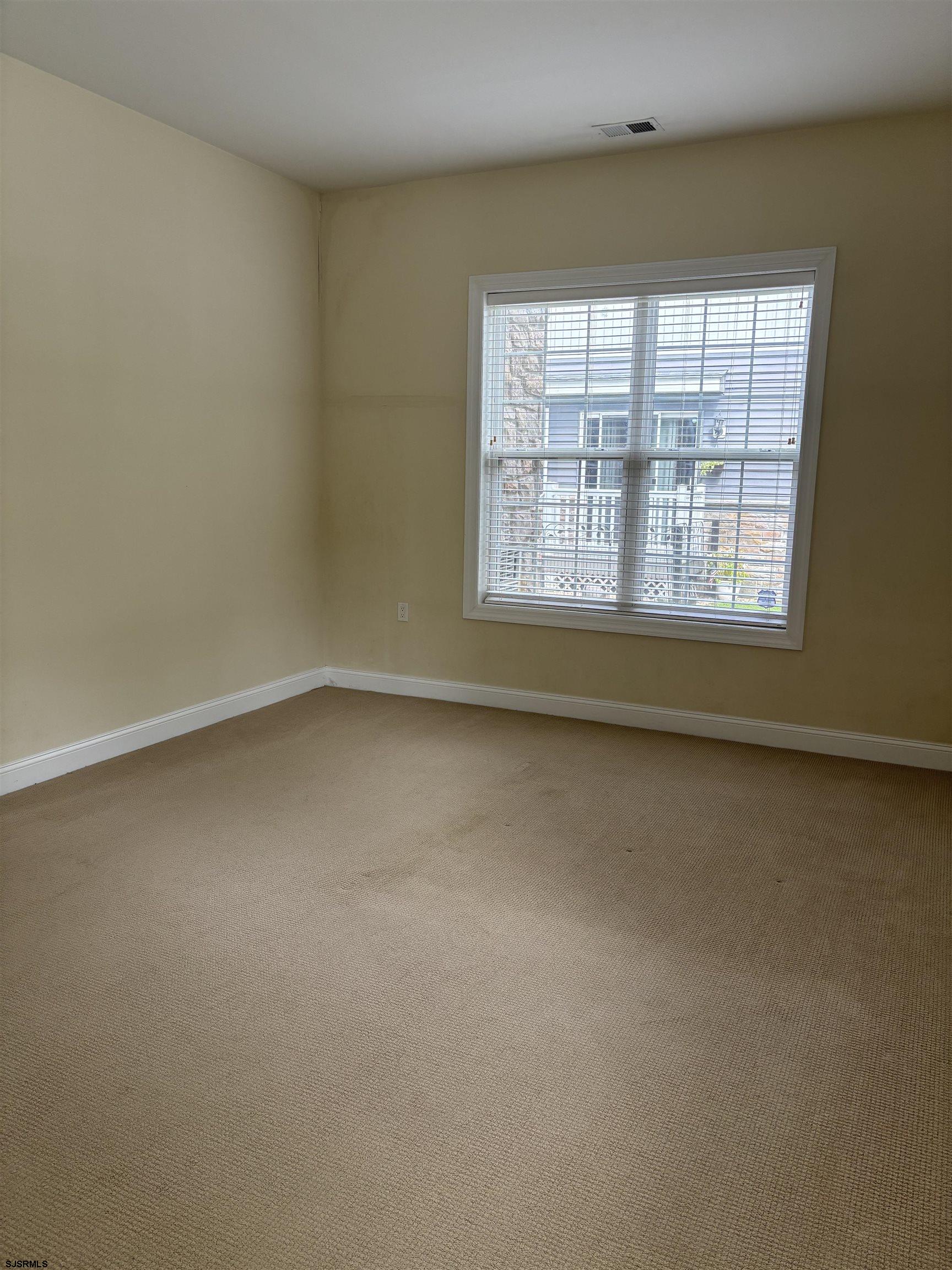 1 Mechanic Street, Unit 108 Absecon, NJ 08201 - Photo 11 of 28 an empty room with a window