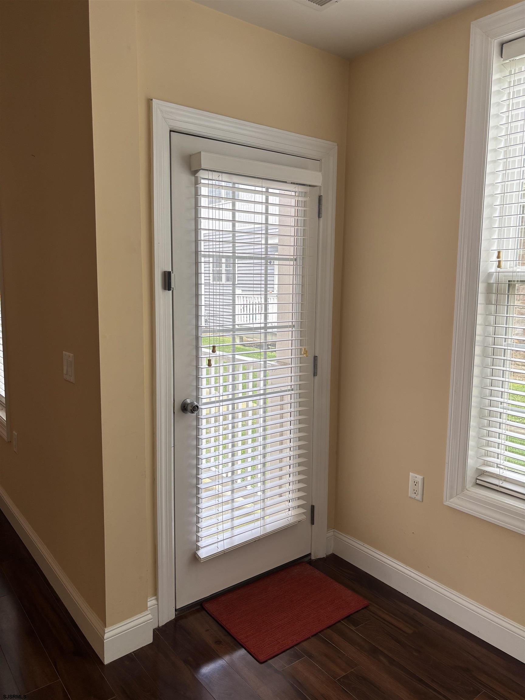1 Mechanic Street, Unit 108 Absecon, NJ 08201 - Photo 18 of 28 a view of an empty room with wooden floor and a window