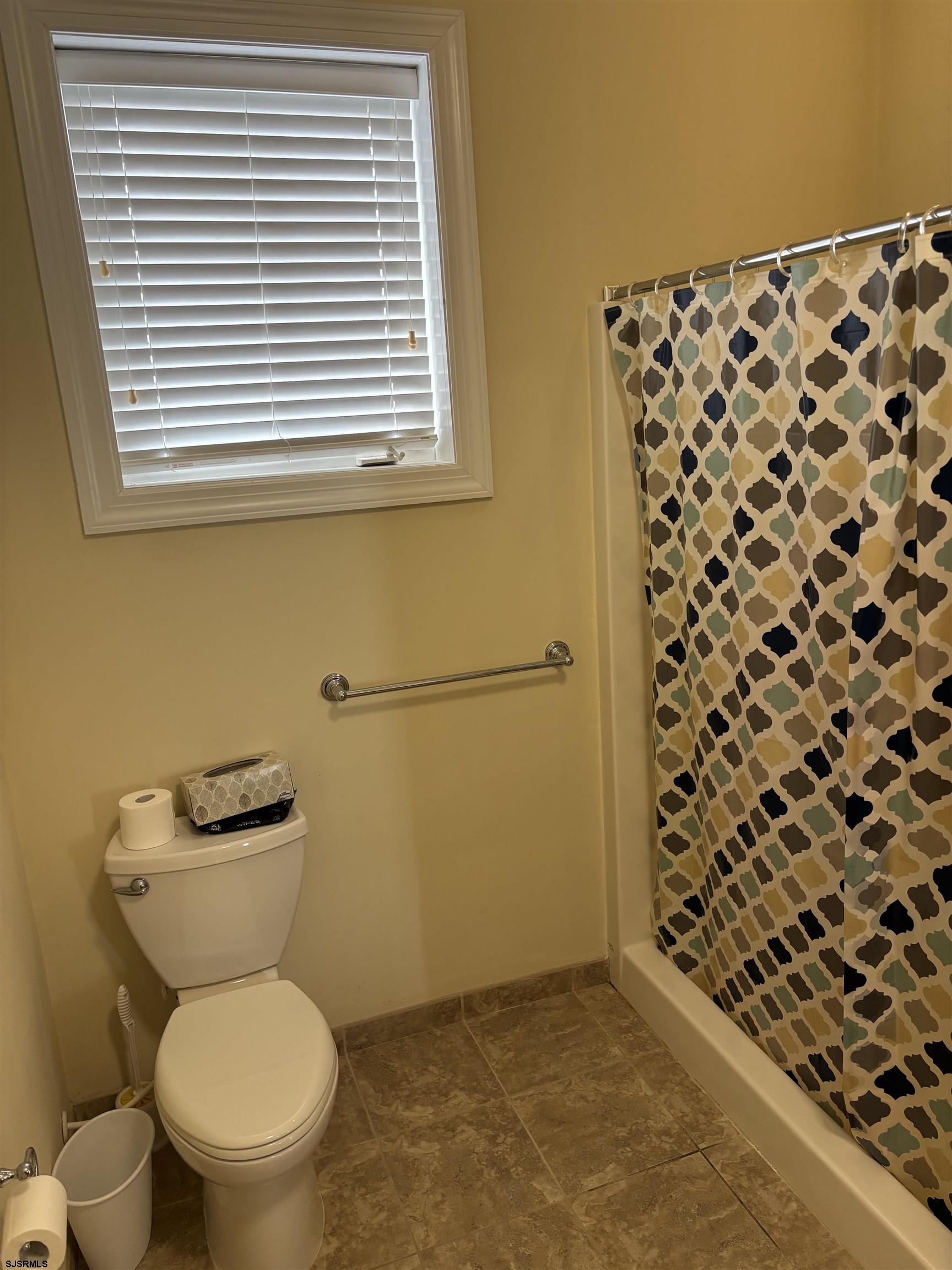 1 Mechanic Street, Unit 108 Absecon, NJ 08201 - Photo 10 of 28 a bathroom with a toilet and a shower curtain