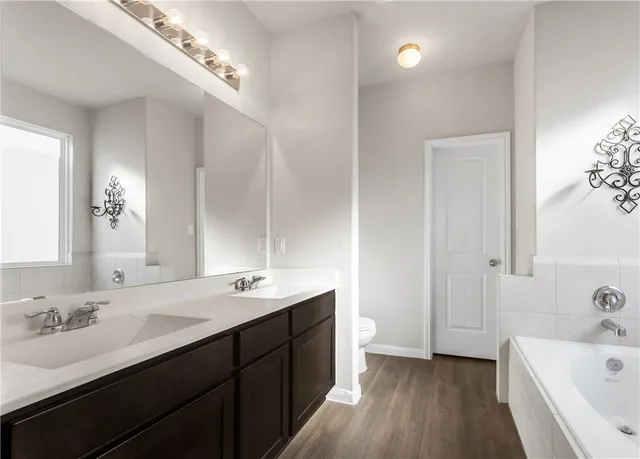 a spacious bathroom with a bathtub and a shower