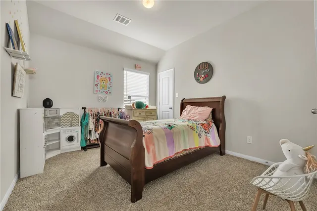 a bedroom with a bed and a table