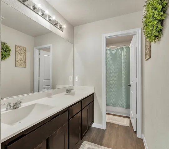 a bathroom with a sink a toilet and mirror