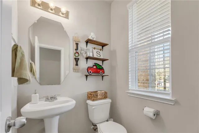 a view of a house with a large window and wooden fence