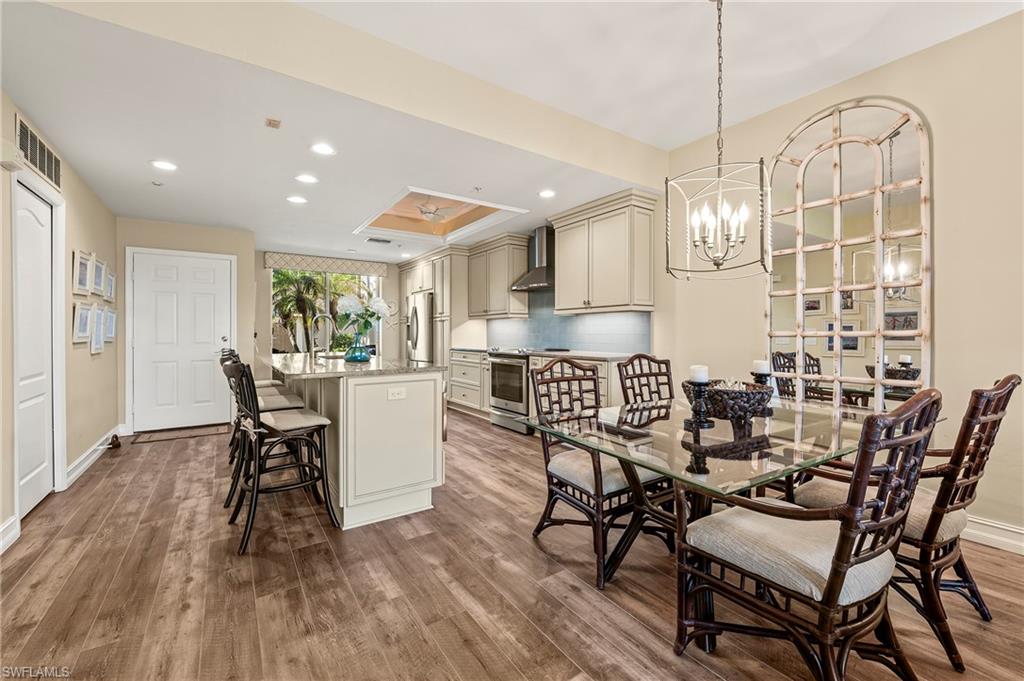 26901 Clarkston Drive, Unit 106 Bonita Springs, FL 34135 - Photo 11 of 24 a dining room with furniture and wooden floor