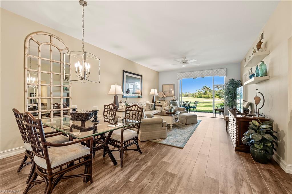26901 Clarkston Drive, Unit 106 Bonita Springs, FL 34135 - Photo 12 of 24 a view of a dining room with furniture and wooden floor