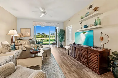 a living room with furniture a bed and a window