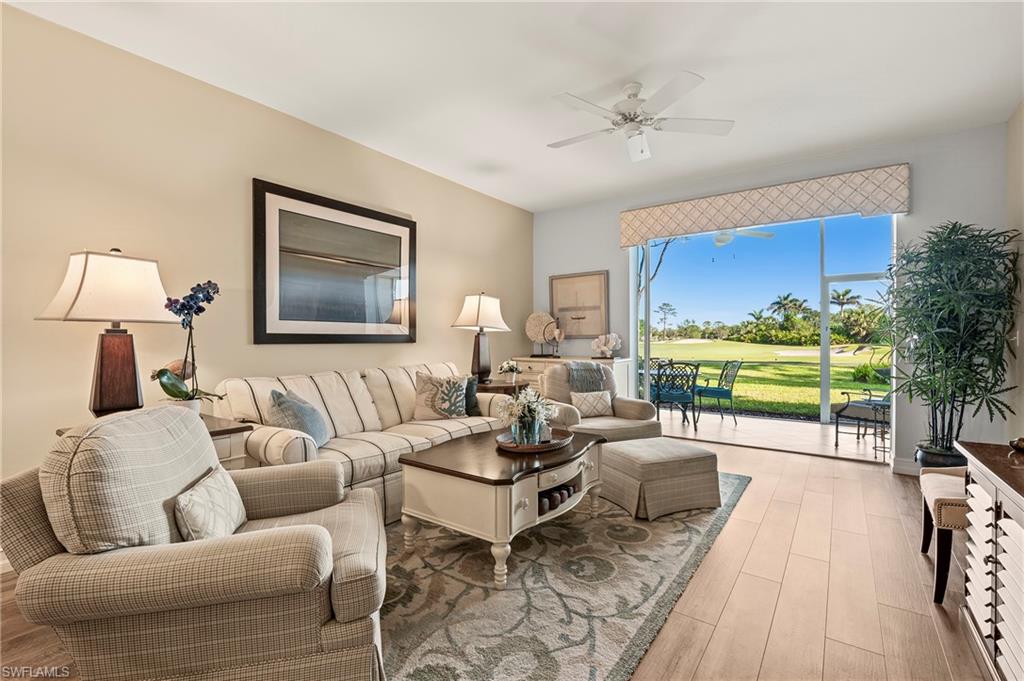 26901 Clarkston Drive, Unit 106 Bonita Springs, FL 34135 - Photo 15 of 24 a living room with furniture and a large window
