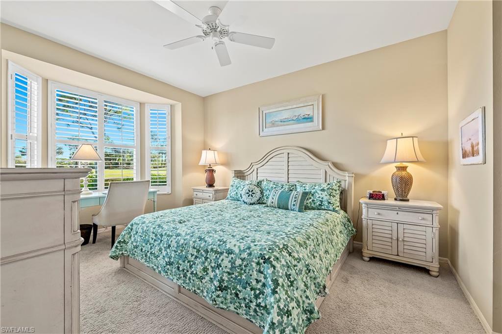 26901 Clarkston Drive, Unit 106 Bonita Springs, FL 34135 - Photo 19 of 24 a bedroom with a bed dresser and a window