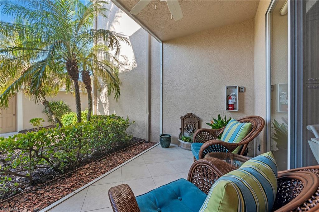 26901 Clarkston Drive, Unit 106 Bonita Springs, FL 34135 - Photo 2 of 24 a outdoor living room with furniture
