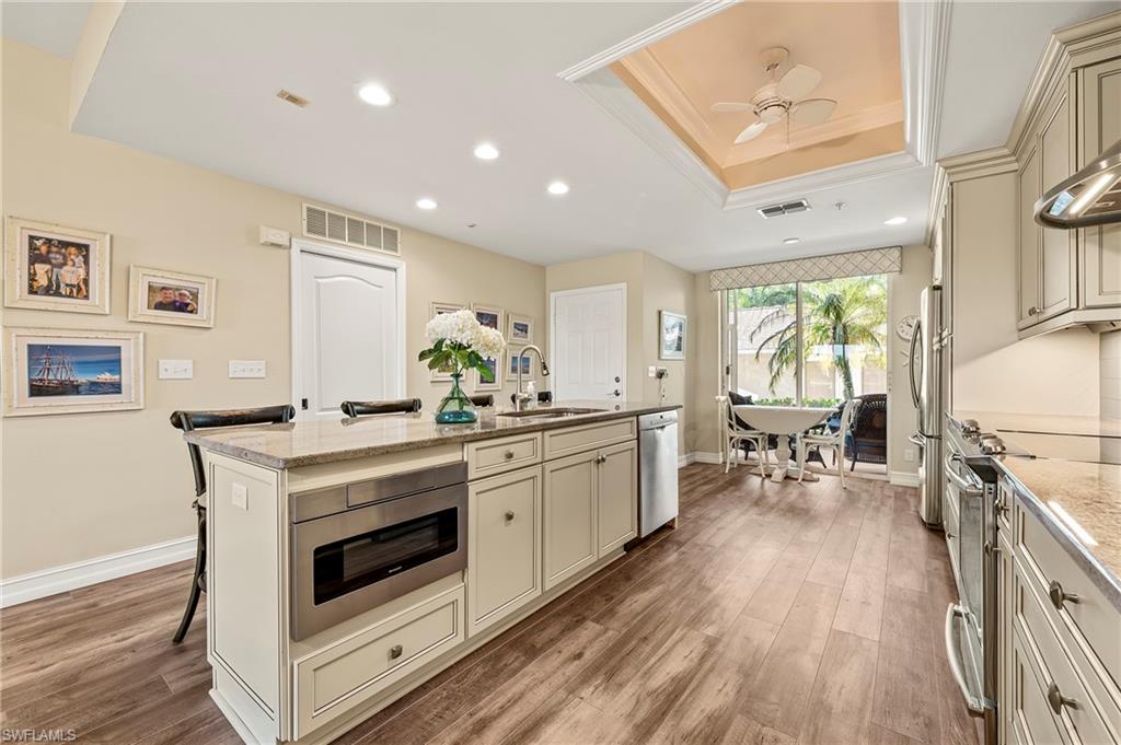 26901 Clarkston Drive, Unit 106 Bonita Springs, FL 34135 - Photo 6 of 24 a kitchen with a stove a sink and a refrigerator