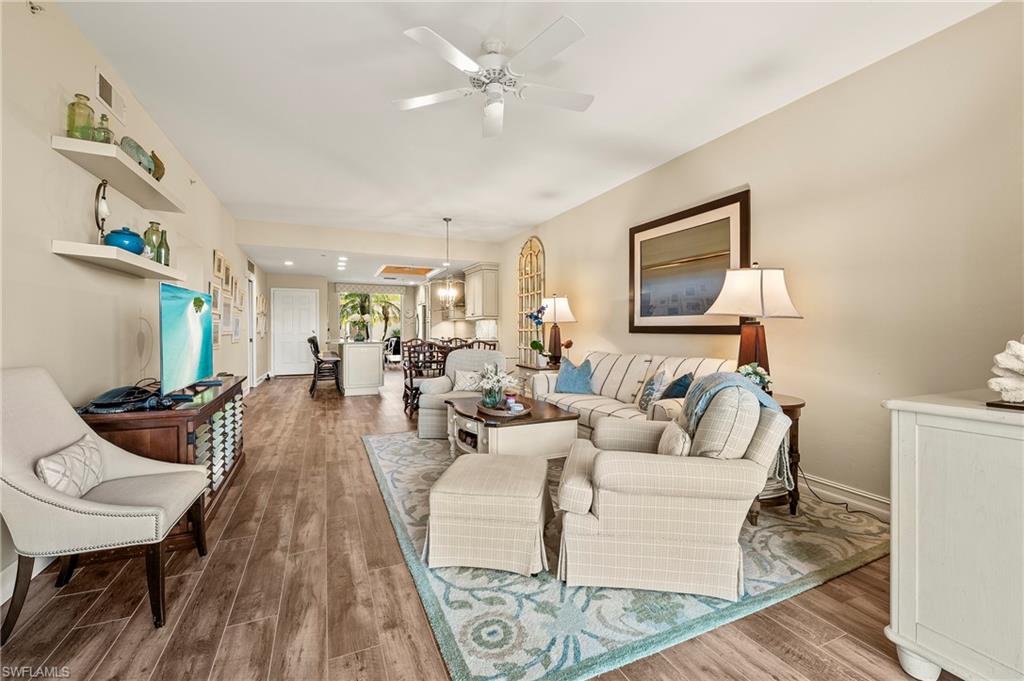 26901 Clarkston Drive, Unit 106 Bonita Springs, FL 34135 - Photo 8 of 24 a living room with furniture and a wooden floor